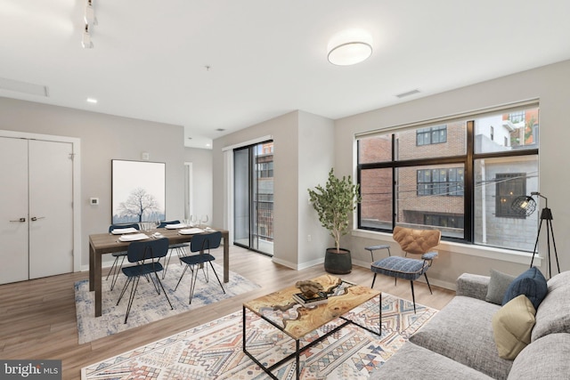 living room featuring wood finished floors and baseboards