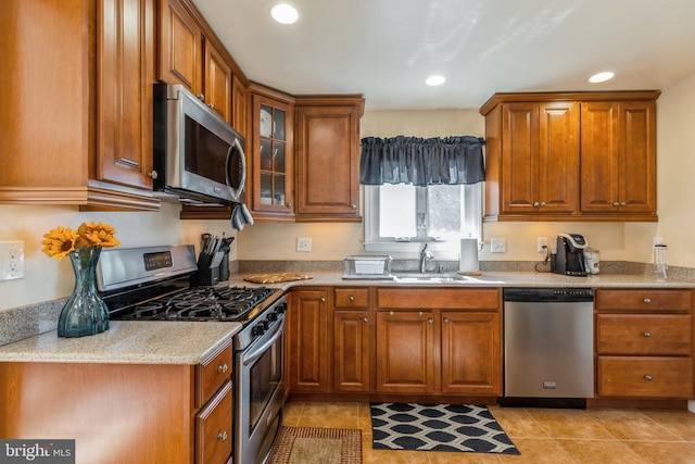 22 N Browning Ave, Somerdale, NJ 08083 - kitchen with stainless steel appliances, brown cabinetry, a sink, glass insert cabinets, and recessed lighting