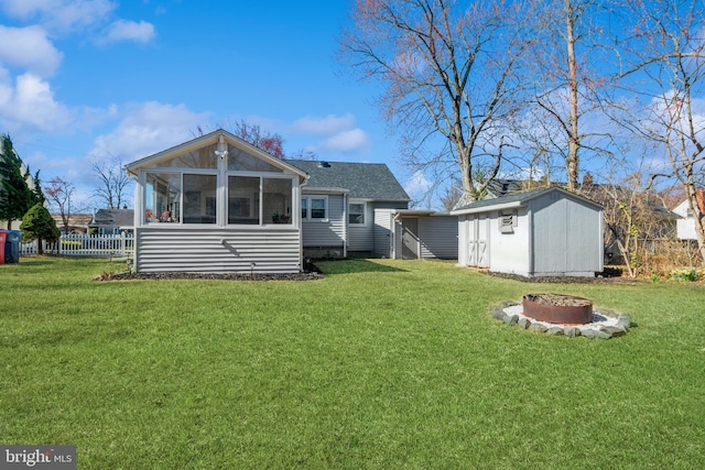 22 N Browning Ave, Somerdale, NJ 08083 - rear view of house with an outdoor fire pit, a sunroom, a storage unit, an outbuilding, and a shingled roof