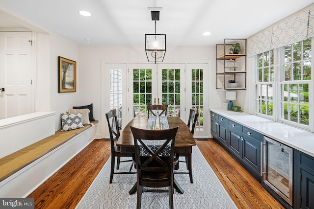 dining area with wine cooler, dark wood finished floors, french doors, and recessed lighting