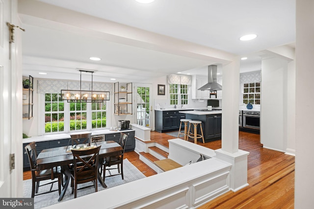 dining space with a chandelier, light wood finished floors, and recessed lighting