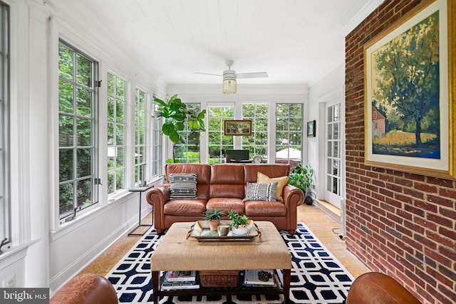 sunroom / solarium with healthy amount of natural light and brick wall