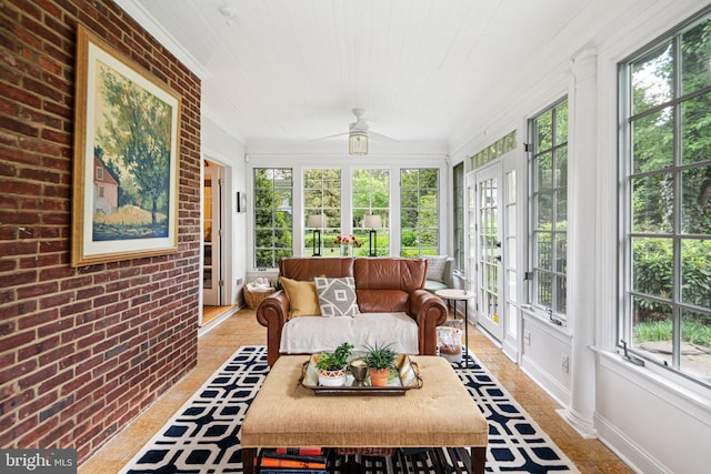 sunroom / solarium featuring french doors, baseboards, brick wall, ornamental molding, and wood ceiling