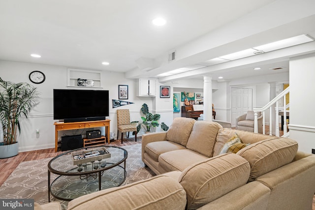 living area featuring ornate columns, wood finished floors, recessed lighting, and baseboards
