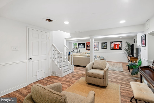 living area featuring wood finished floors, stairway, recessed lighting, and baseboards