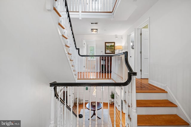 stairs featuring wood finished floors and baseboards