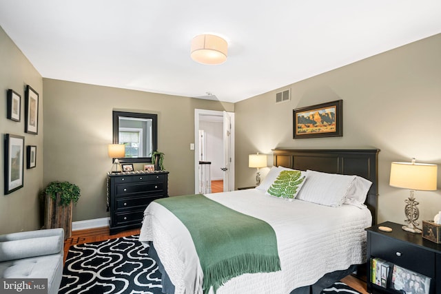 bedroom featuring wood finished floors and baseboards