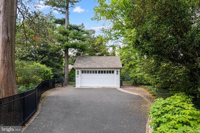 detached garage featuring fence