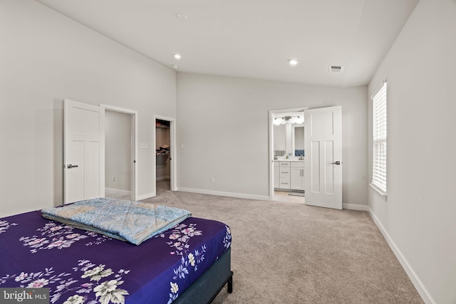 bedroom with baseboards, ensuite bathroom, vaulted ceiling, a spacious closet, and carpet floors