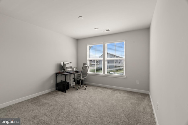 carpeted home office featuring baseboards and visible vents