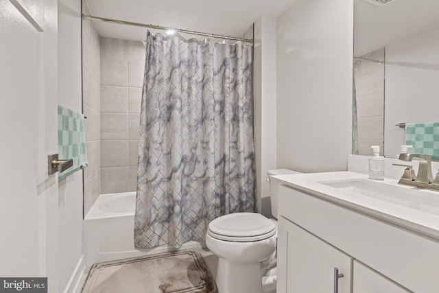 bathroom with toilet, vanity, and shower / bathtub combination with curtain
