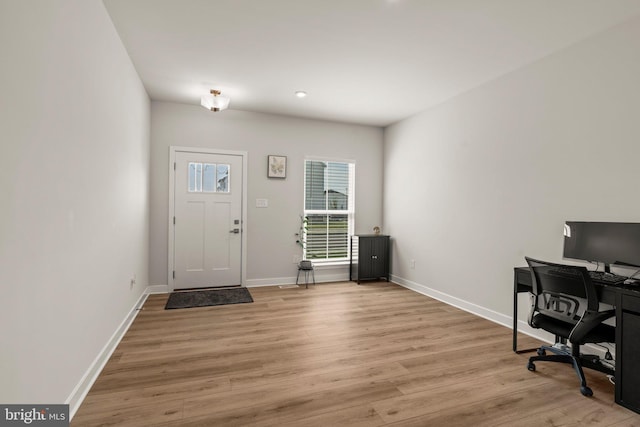foyer entrance with light wood finished floors, baseboards, and recessed lighting