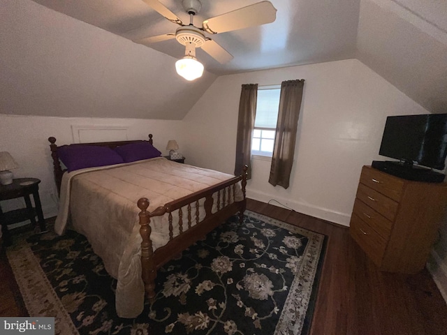 bedroom featuring wood finished floors, lofted ceiling, baseboards, and ceiling fan