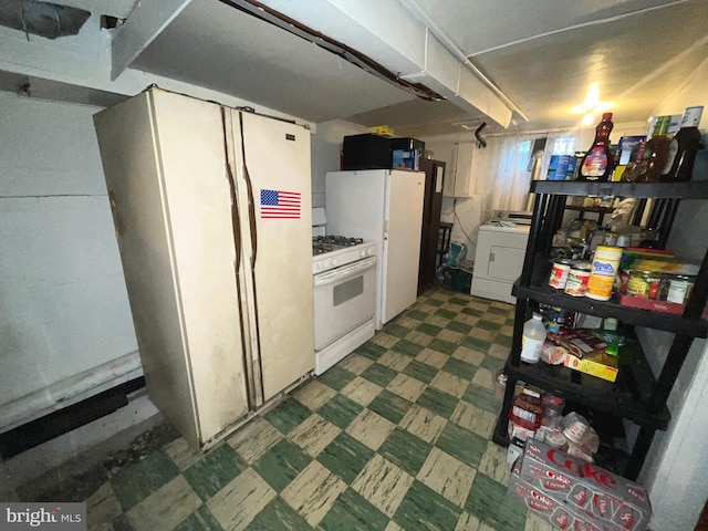 kitchen with white appliances, washer / clothes dryer, and tile patterned floors