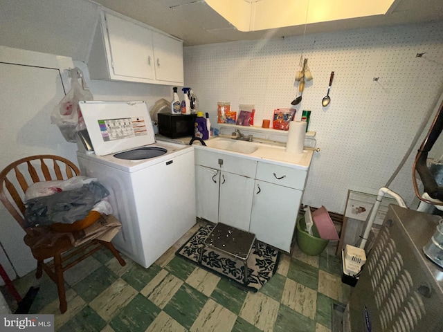 clothes washing area with washer / clothes dryer, tile patterned floors, and cabinet space