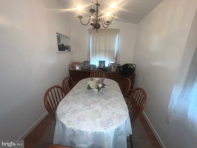 dining space with a chandelier and baseboards