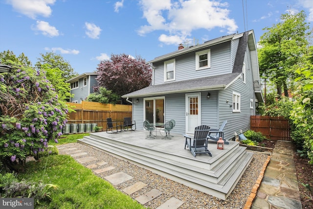 4311 Ellicott St NW, Washington, DC 20016 - back of property featuring fence, a wooden deck, a chimney, and roof with shingles