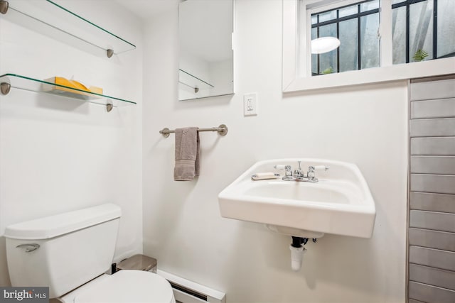 4311 Ellicott St NW, Washington, DC 20016 - bathroom with toilet, a baseboard heating unit, and a sink