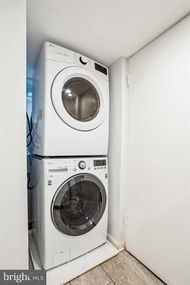 4311 Ellicott St NW, Washington, DC 20016 - laundry area with stacked washer / drying machine and baseboards