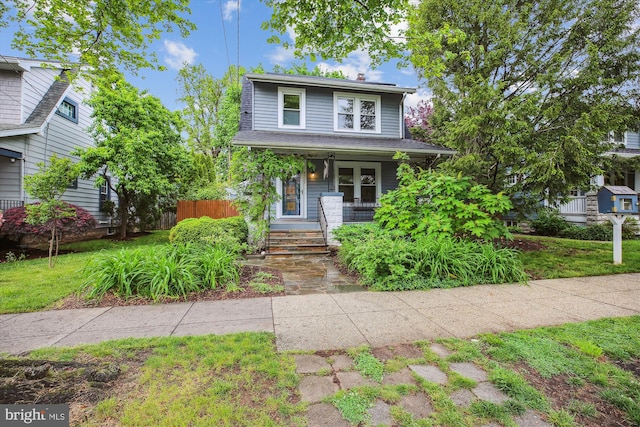 4311 Ellicott St NW, Washington, DC 20016 - view of front facade featuring covered porch and fence