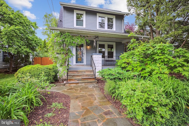 4311 Ellicott St NW, Washington, DC 20016 - american foursquare style home with a porch, french doors, and fence