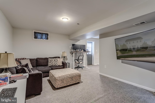 carpeted living room with baseboards