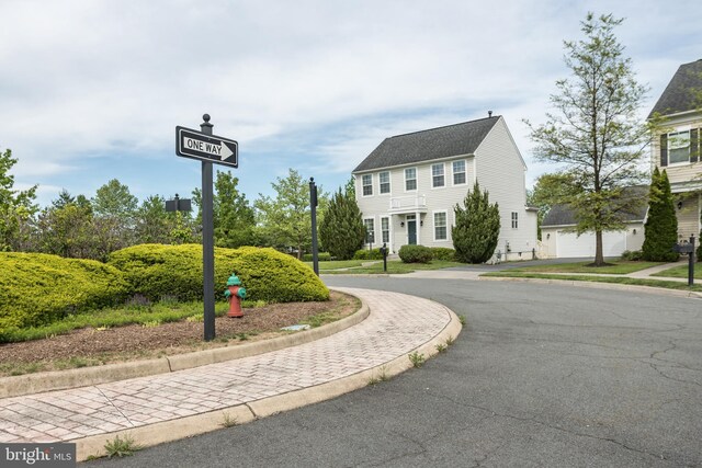 view of asphalt road featuring sidewalks and curbs
