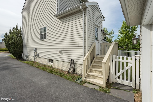 view of home's exterior featuring fence and crawl space