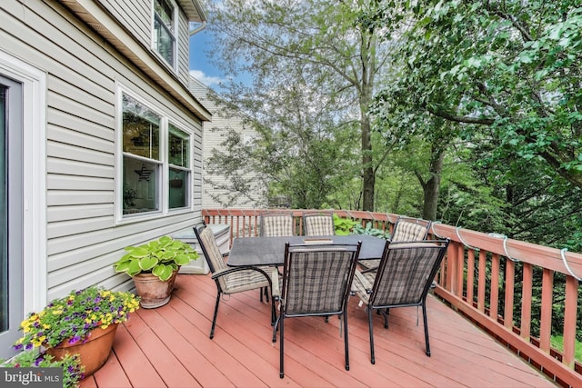 wooden terrace with outdoor dining area