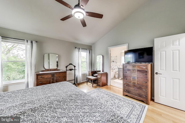 bedroom with ensuite bathroom, wood finished floors, a ceiling fan, and high vaulted ceiling