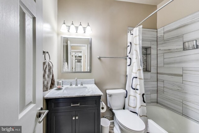 bathroom with vanity, toilet, and shower / tub combo