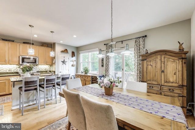 dining space featuring light wood finished floors and recessed lighting