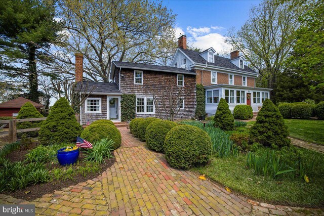 view of front of property with fence and a chimney