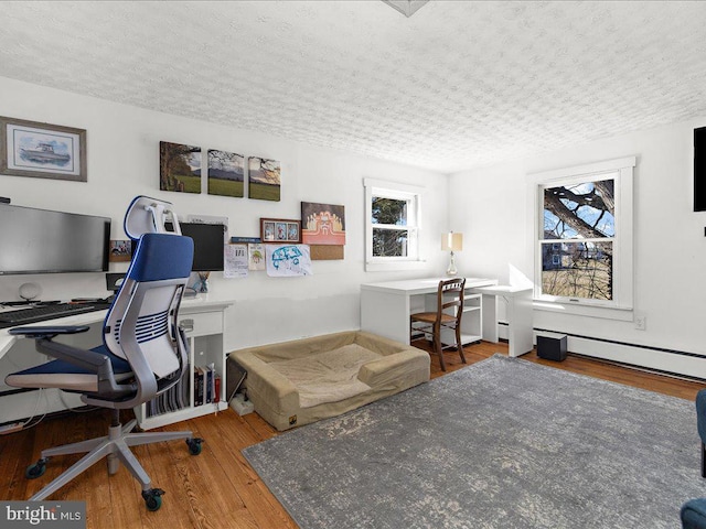 office with wood finished floors and a textured ceiling