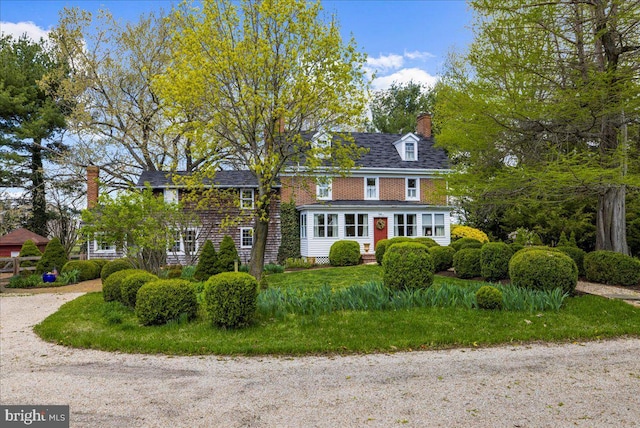 view of front of house featuring a chimney