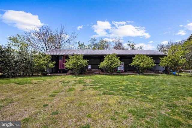 ranch-style house with a front yard and metal roof