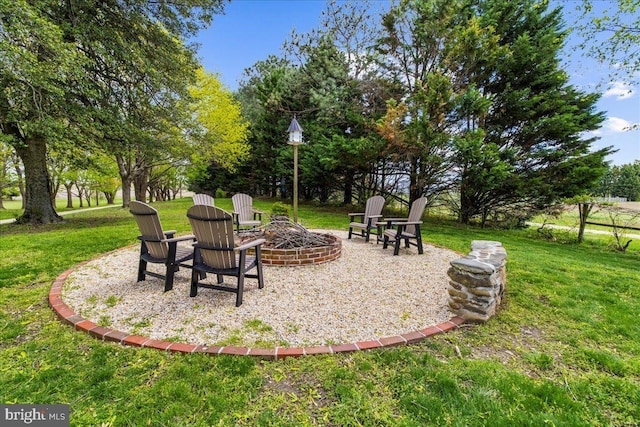 view of grassy yard with a fire pit