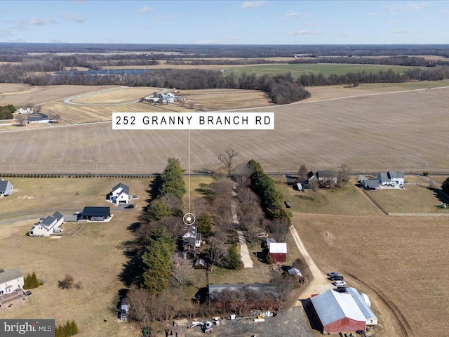 aerial view of property and surrounding area featuring rural landscape