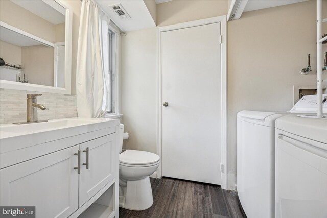 417 Jamestown Ct, Mount Laurel, NJ 08054 - bathroom featuring washing machine and dryer, toilet, wood finished floors, backsplash, and vanity