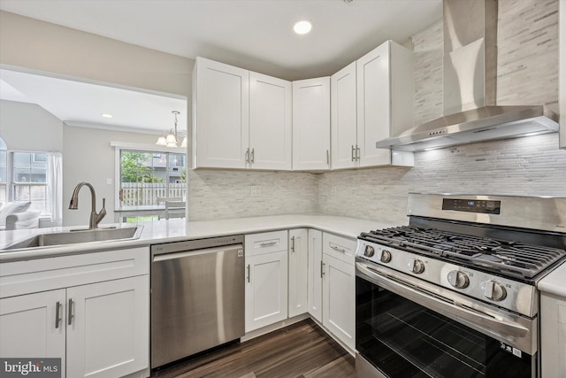 417 Jamestown Ct, Mount Laurel, NJ 08054 - kitchen featuring stainless steel appliances, wall chimney range hood, a sink, a chandelier, and white cabinetry