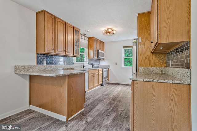 22 Hillside Ct, Huntingtown, MD 20639 - kitchen with stainless steel appliances, baseboards, wood finished floors, tasteful backsplash, and a textured ceiling