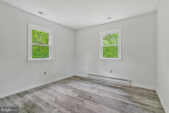 22 Hillside Ct, Huntingtown, MD 20639 - empty room featuring baseboard heating, wood finished floors, and baseboards