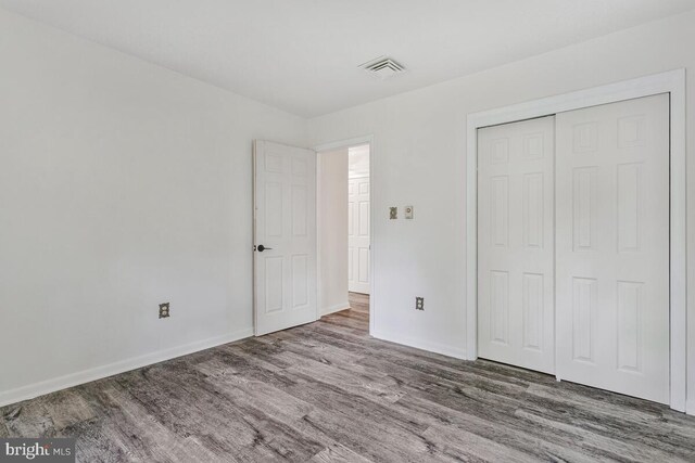 22 Hillside Ct, Huntingtown, MD 20639 - unfurnished bedroom featuring wood finished floors, baseboards, and a closet