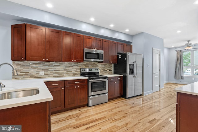 823 N 15th St Unit 1, Philadelphia, PA 19130 - kitchen with a sink, stainless steel appliances, light wood-type flooring, light countertops, and decorative backsplash