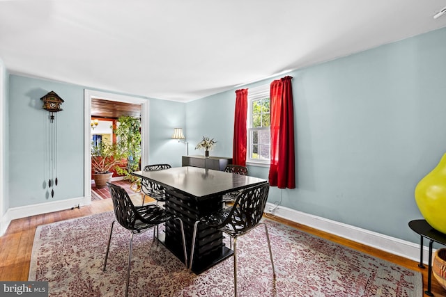 dining room with wood finished floors and baseboards