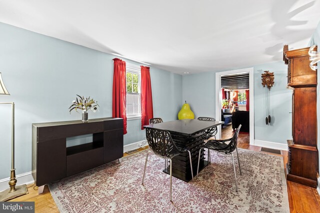 dining area featuring wood finished floors and baseboards