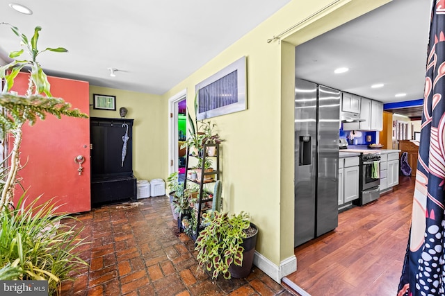 hallway featuring baseboards and recessed lighting