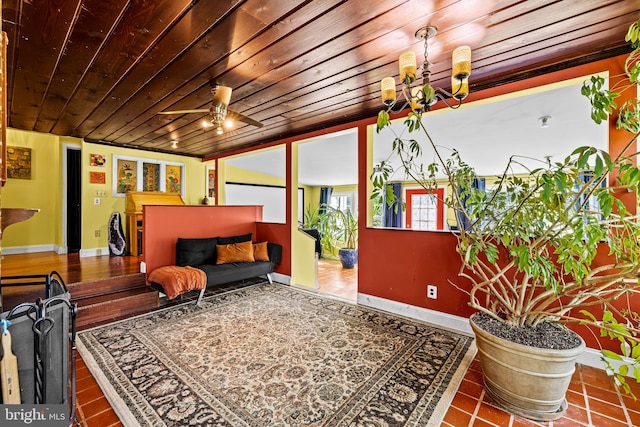 sitting room featuring wood ceiling, a chandelier, and baseboards