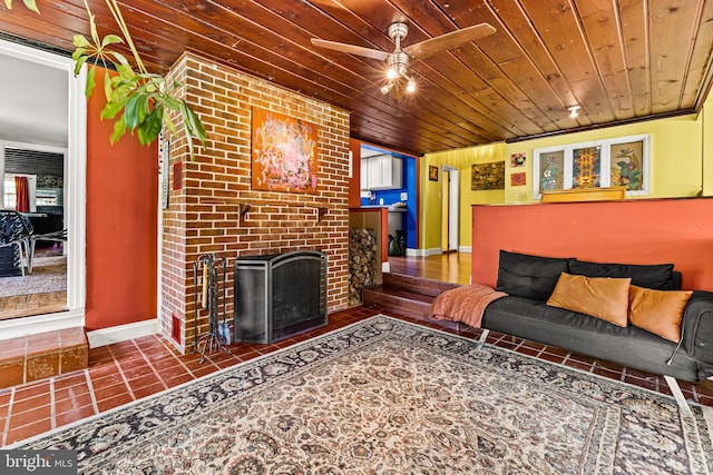living area with wooden ceiling, a ceiling fan, a fireplace, and baseboards
