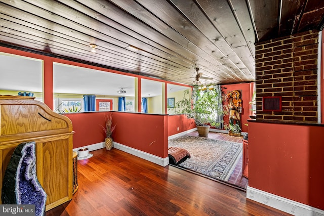 interior space with wooden ceiling, wood finished floors, and baseboards
